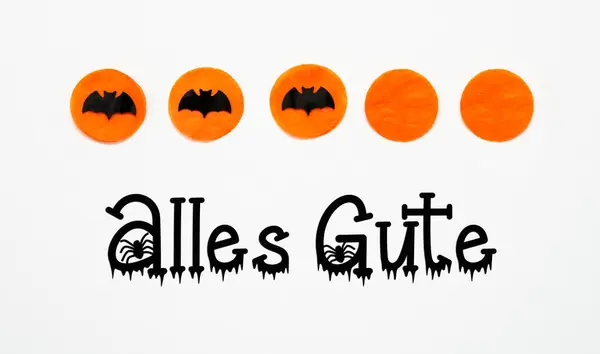 White Halloween Background With Orange Dots And Black Bats And German Text Alles Gute, Which Means Best Wishes In English
