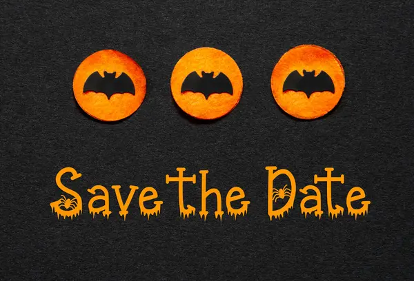 Black Halloween Background With Three Orange Dots With Bats And Text Save The Date