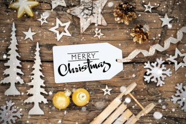 Kırsal Ahşap ve Altın Noel Arkaplanı, Kar yağışlı Noel Dekoru ve Mutlu Noeller yazılı etiket