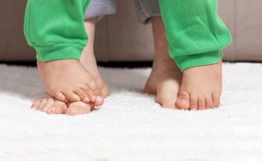 Cropped shot of a mother and her baby boy's feet together
