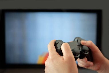 Unrecognizable man using a controller while playing computer games