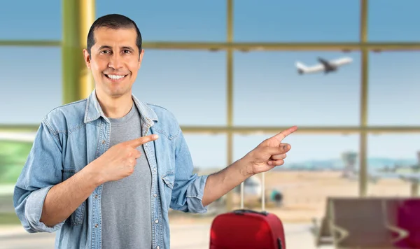 Man Standing Smiling Airport Looking Camera Pointing Two Hands Fingers Stockafbeelding