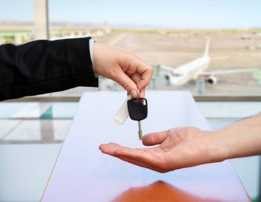 Cropped shot of unrecognizable stewardess returning giving car key at airport