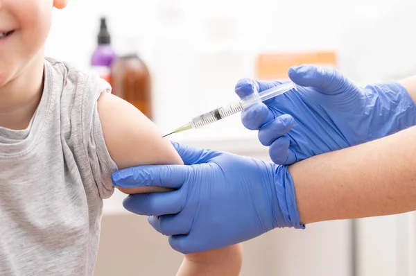 stock image Shot of a little boy getting a vaccination in a hospital smiling and fearless