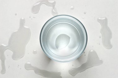 Spilled water glass with white background