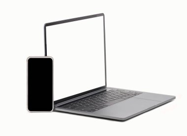 Modern laptop and smart phone isolated on a white background on table