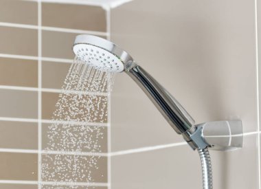 Close to the water shower head that is closed