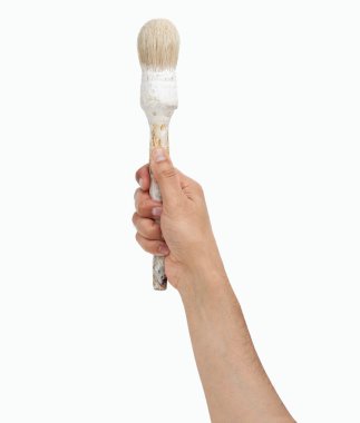 Man hand holding an old paintbrush ready to paint isolated on a white background