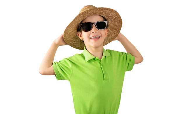 帽子を拾う白い隔離された背景の上に緑のTシャツの帽子とサングラスを身に着けて休暇中の子供 正の人 — ストック写真