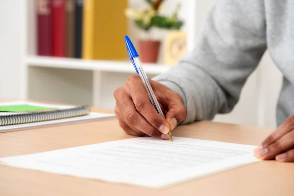 Close Black Man Hands Signing Document Desk Home — Stock fotografie