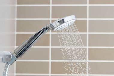 Close to the water shower head that is closed