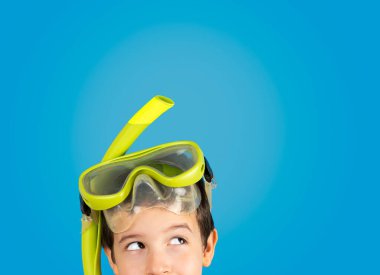 Cropped image of a man with mask tuba and snorkel with thinking about question, thoughtful expression.Concept of doubt and looking aside.Copy space and isolated on blue background clipart