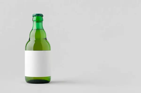 stock image Green steinie beer bottle mockup with blank label and copyspace.