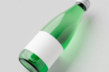 Small water bottle mockup with blank label. Green glass, closeup. clipart