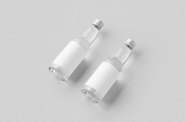 Miniature spirits, liquor bottle mockup. Clear glass and liquid with a blank label. clipart