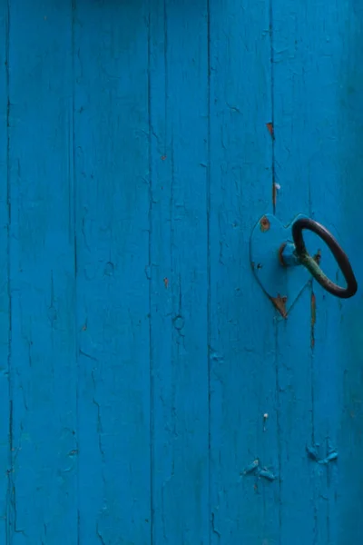 Blue antique door with iron handle