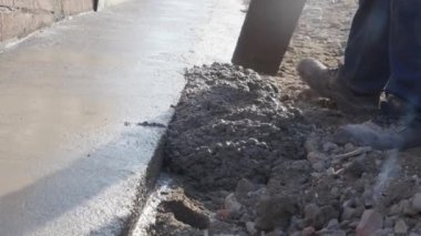 Alçı işçiliği İnşaat işçisi, betonun tepesini betonla kaplayarak istenen pürüzsüzlüğe ulaşmak için kaldırım döşemesi kullanıyor.