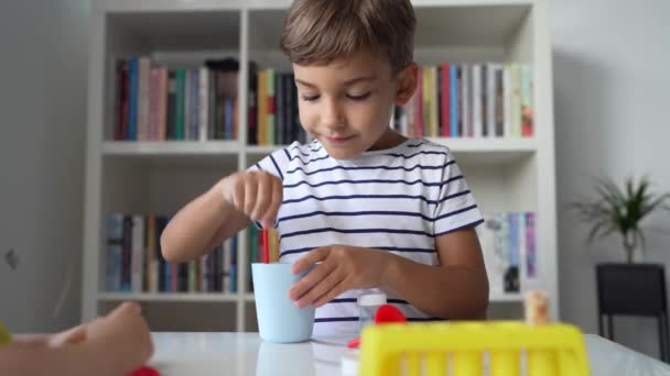 Один Дошкольник Играет Дома Сидя Столом Научными Экспериментами Игрушки Смотрят — стоковое видео