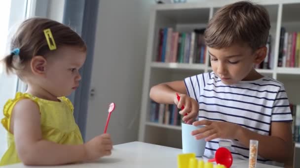 One Preschool Boy Playing Home Science Experiments While His Little — Stock Video