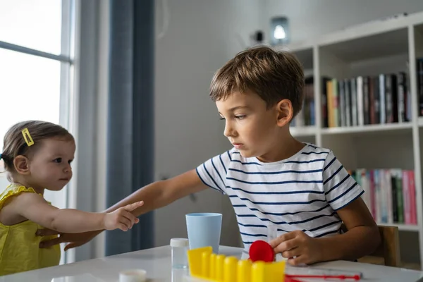 One Preschool Boy Playing Home Science Experiments While His Little — Stock Photo, Image