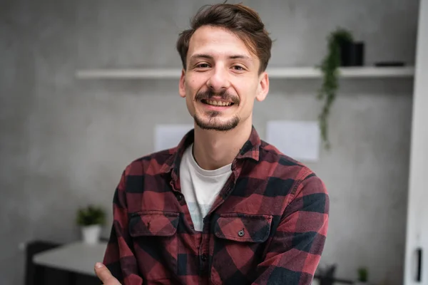 One man young adult caucasian male standing at office at work with brown hair mustaches and beard looking to the camera happy smile confident real people copy space