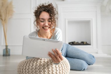 One woman young caucasian use digital tablet on the floor at home