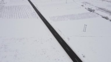 Car drive in snow winter day on the road in with snow aerial view 