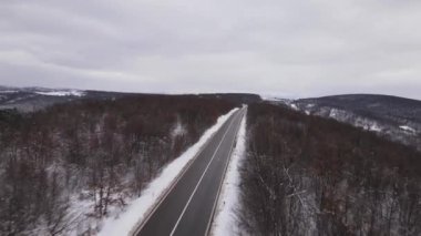 Car drive in snow winter day on the road in with snow aerial view 