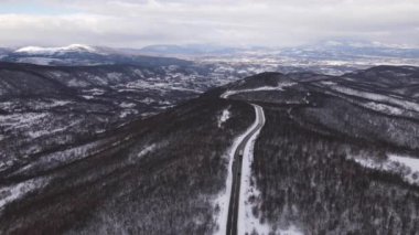 Car drive in snow winter day on the road in with snow aerial view 
