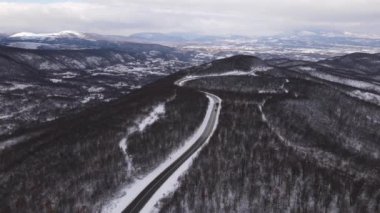 Car drive in snow winter day on the road in with snow aerial view 