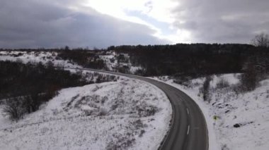 Car drive in snow winter day on the road in with snow aerial view 
