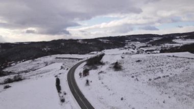 Car drive in snow winter day on the road in with snow aerial view 