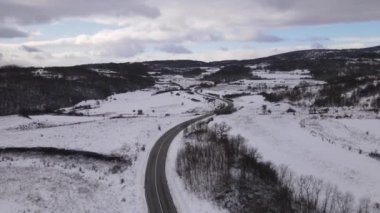 Car drive in snow winter day on the road in with snow aerial view 