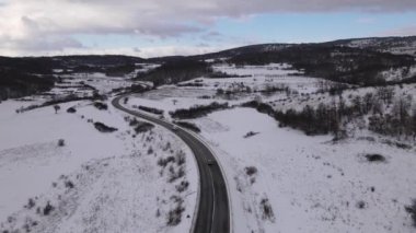 Car drive in snow winter day on the road in with snow aerial view 