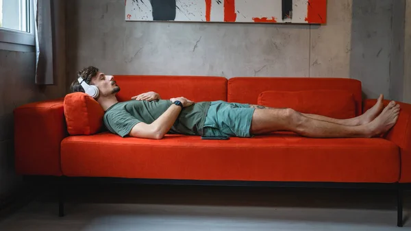 One Man Adult Caucasian Male Bed Sofa Use Headphones Online — Stock fotografie