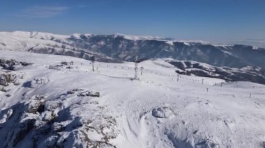Stara Planina babin Zub Ski track with Gondola type cable car  transport Skiers on snow covered slope of ski resort Landscape with snowy piste Aerial drone view old mountain Balkan