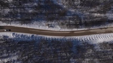 Car drive in snow winter day on the road in mountain range aerial view old mountain stara planina babin zub top down