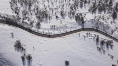 Car drive in snow winter day on the road in mountain range aerial drone view old mountain stara planina babin zub 