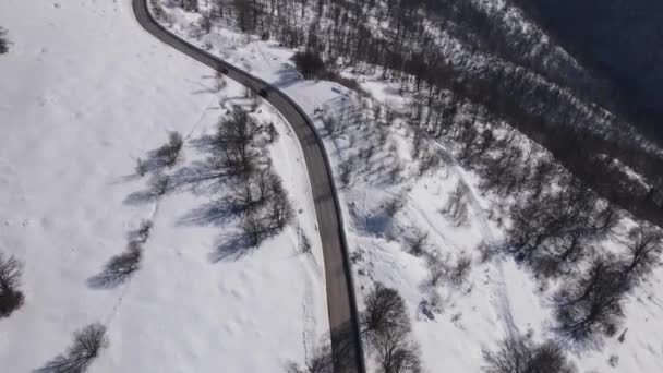 Car Drive Snow Winter Day Road Mountain Range Aerial Drone — kuvapankkivideo