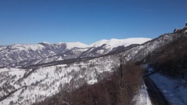 Old Mountain Balkan Stara Planina Babin Zub tourist resort in winter day covered with snow empty road