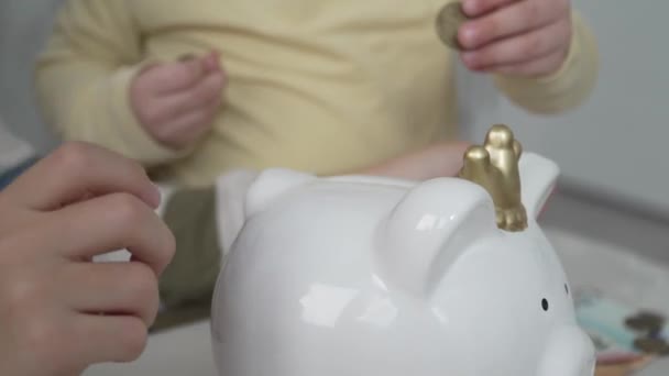 Close Hands Unknown Children Putting Money Coins Piggy Bank Finance — Stok video