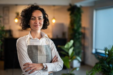 One mature woman caucasian female gardener or florist take care and cultivate domestic flowers plants at home gardening concept copy space