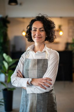 One mature woman caucasian female gardener or florist take care and cultivate domestic flowers plants at home gardening concept copy space