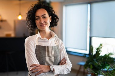 One mature woman caucasian female gardener or florist take care and cultivate domestic flowers plants at home gardening concept copy space