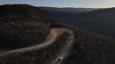 Aerial view on the road with cars automobile passing driving travel concept in autumn or winter day trough the trees on asphalt on Tresibaba Serbia