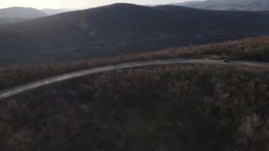 Aerial view on the road with cars automobile passing driving travel concept in autumn or winter day trough the trees on asphalt on Tresibaba Serbia