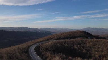 Aerial view on the road with cars automobile passing driving travel concept in autumn or winter day trough the trees on asphalt on Tresibaba Serbia