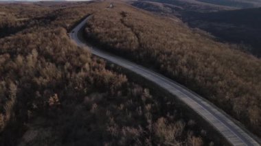 Aerial view on the road with cars automobile passing driving travel concept in autumn or winter day trough the trees on asphalt on Tresibaba Serbia