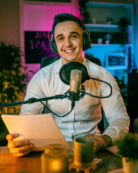 One man caucasian male blogger or vlogger gesticulating while streaming video podcast in broadcasting studio use microphone and headphones famous influencer shooting video for channel podcast