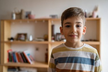 portrait of one caucasian boy preschooler child at home waist up serious